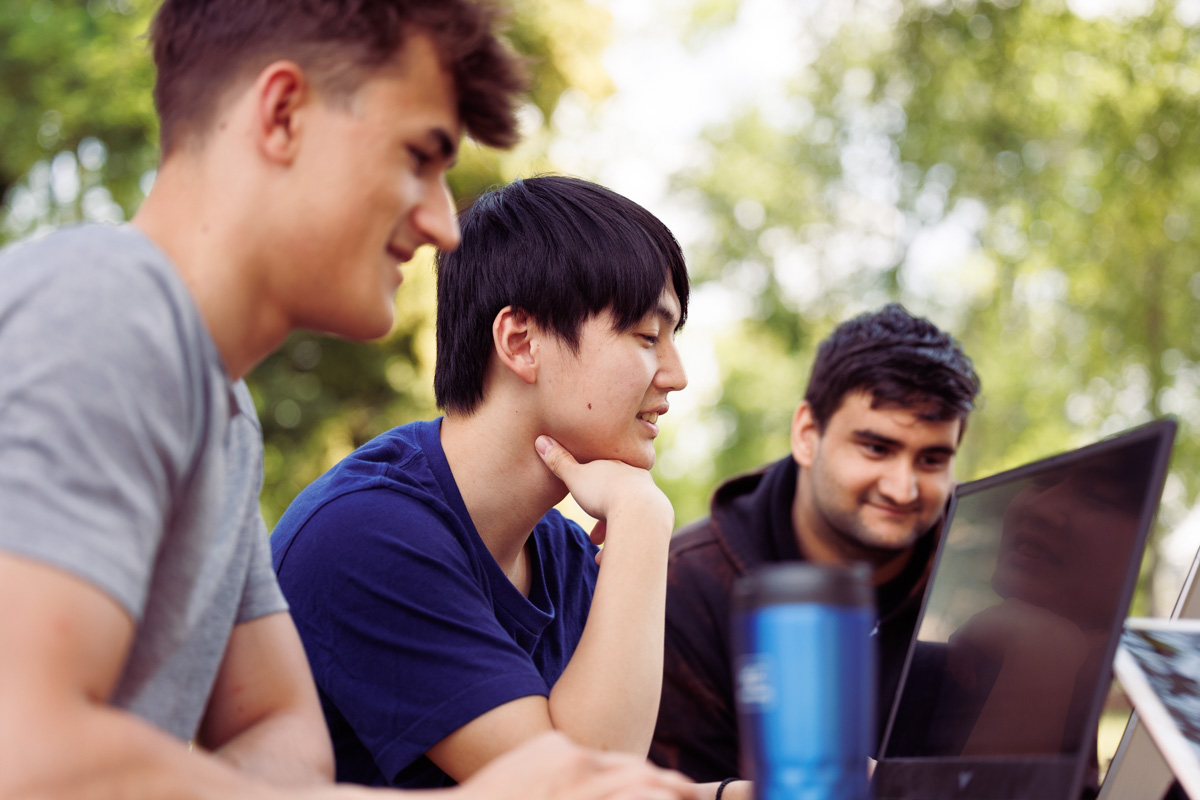 Male Students of different nationalities working together