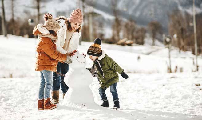 mom and kids playing in the snow